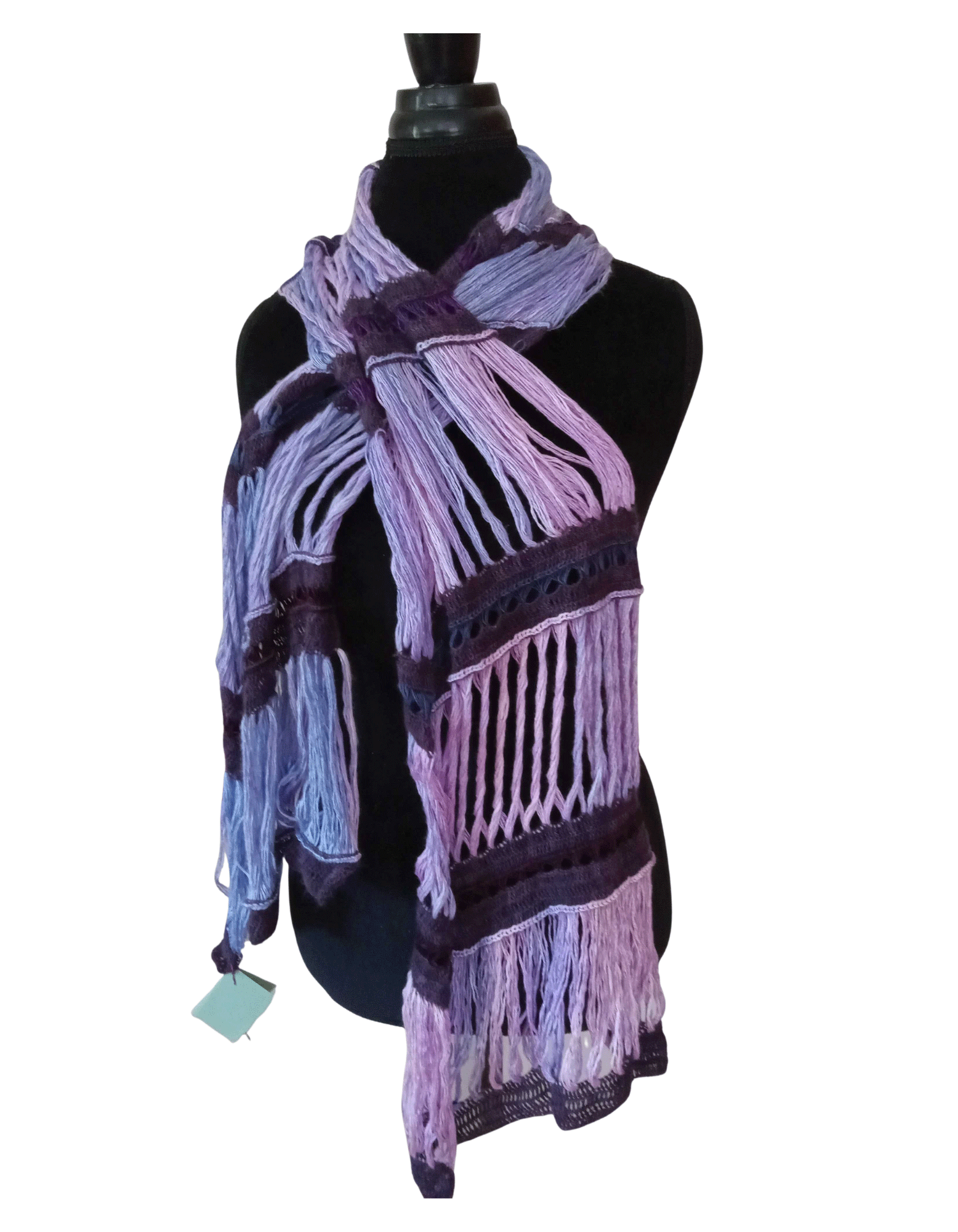 The photo shows an elegant Lady's Scarf with 8 alternating rows of soft lilac loops of yarn held together with bands of dark purple rows of crocheted cashmere. The finished piece is over a foot wide, five feet long and draped over a black velvet dressmaker's mannequin.